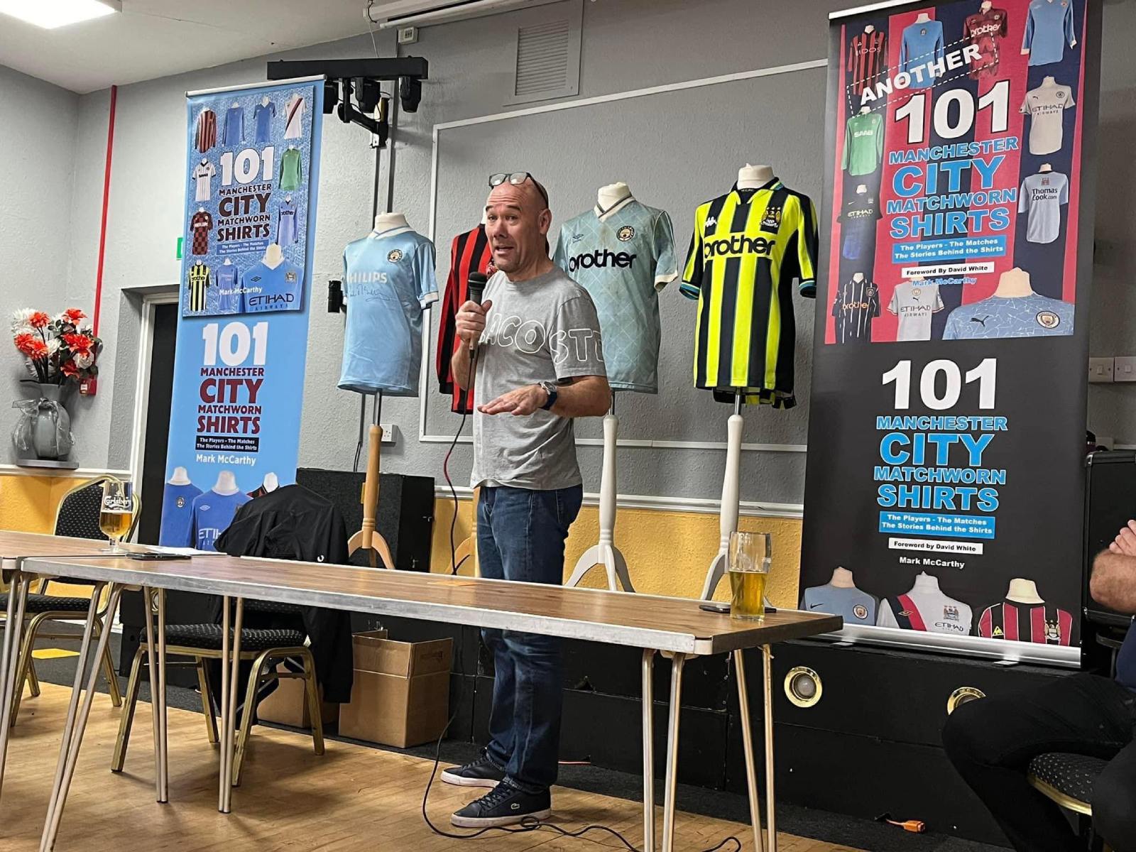 Mark McCarthy speaking at a Manchester City memorabilia event